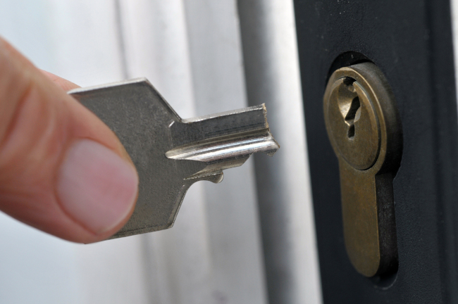 Broken key beside a door lock