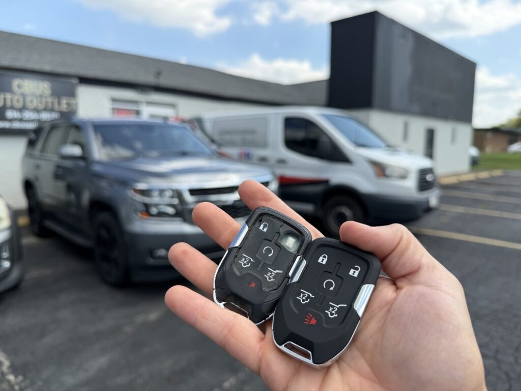 Worn original 2020 Chevrolet Tahoe proximity key next to the new one