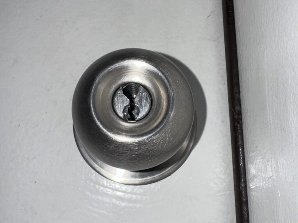 Close-up of a Schlage door knob drilled during an earlier lockout at a Dublin home