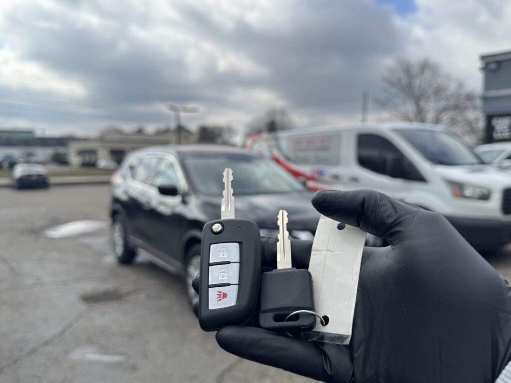 Basic transponder key for a Nissan Rogue next to the new remote key