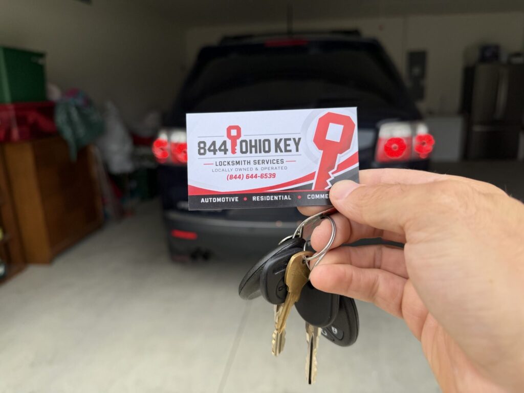 Customer’s original GMC Acadia key and remote beside the new spare key and fob