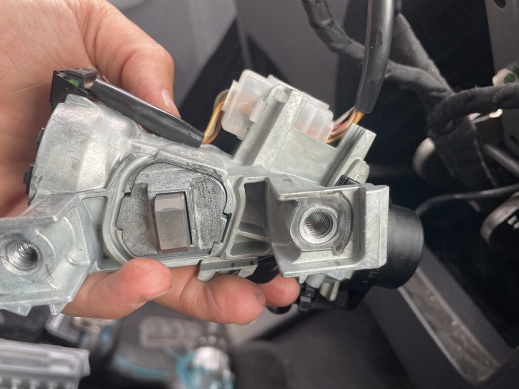 Ignition housing removed from the steering column of a 2012 Volkswagen Jetta, showing the stuck steering lock, Grove City